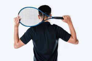 A male tennis player holding a tennis racket with a determined expression and eyes. photo