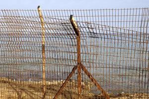 Security fence on the Mediterranean coast. photo