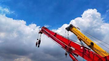 Beautiful red and yellow telescopic crane with blue sky with cloud for background. photo