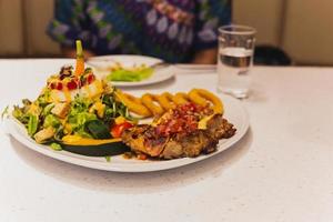 Grilled chicken with vegetables salad on a plate. Healthy Food photo