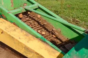 A mechanized method of harvesting potatoes in the village. photo