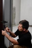 The technique of installing a door lock in an interior door. photo