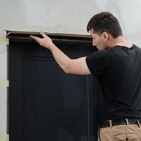 Checking the door frame for evenness of the surface after installation using a metal rule. photo
