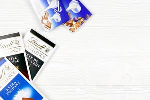 KHARKIV, UKRAINE - DECEMBER 18, 2022 Lindt Chocolate on white background. Lindt and Spruengli AG is a Swiss chocolatier and confectionery company known for their chocolate bars photo