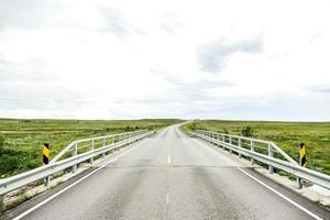 Empty road through rural landscape photo