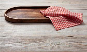 Pizza board, with napkin on wooden table isolated. Top view mockup photo