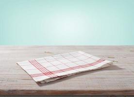 White napkin, table cloth on wooden deck mockup. photo