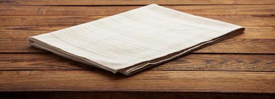 Empty canvas napkin on wooden desk top view photo