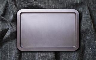 Baking tray with tablecloth, napkin. Top view mockup photo