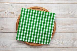 Empty pizza board and napkin on white wooden top view. photo