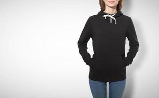 young girl in black sweatshirt, black hoodies front view isolated on white background photo