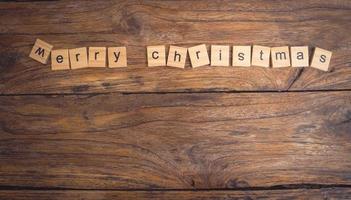 Feliz Navidad. tarjeta de felicitación navideña con madera rústica y adornos. foto