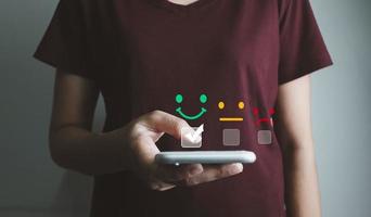 Customer satisfaction very good service with smart phone, impression of take care and attention, choose a smiley face icon, answer the survey, give the highest score, very happy feedback from guest. photo