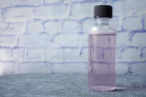 mouthwash liquid in a container on table photo