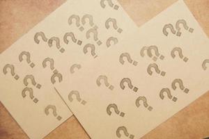 high angle view of many question marks on paper photo