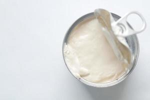 top view of milk cream in a tin container on table photo