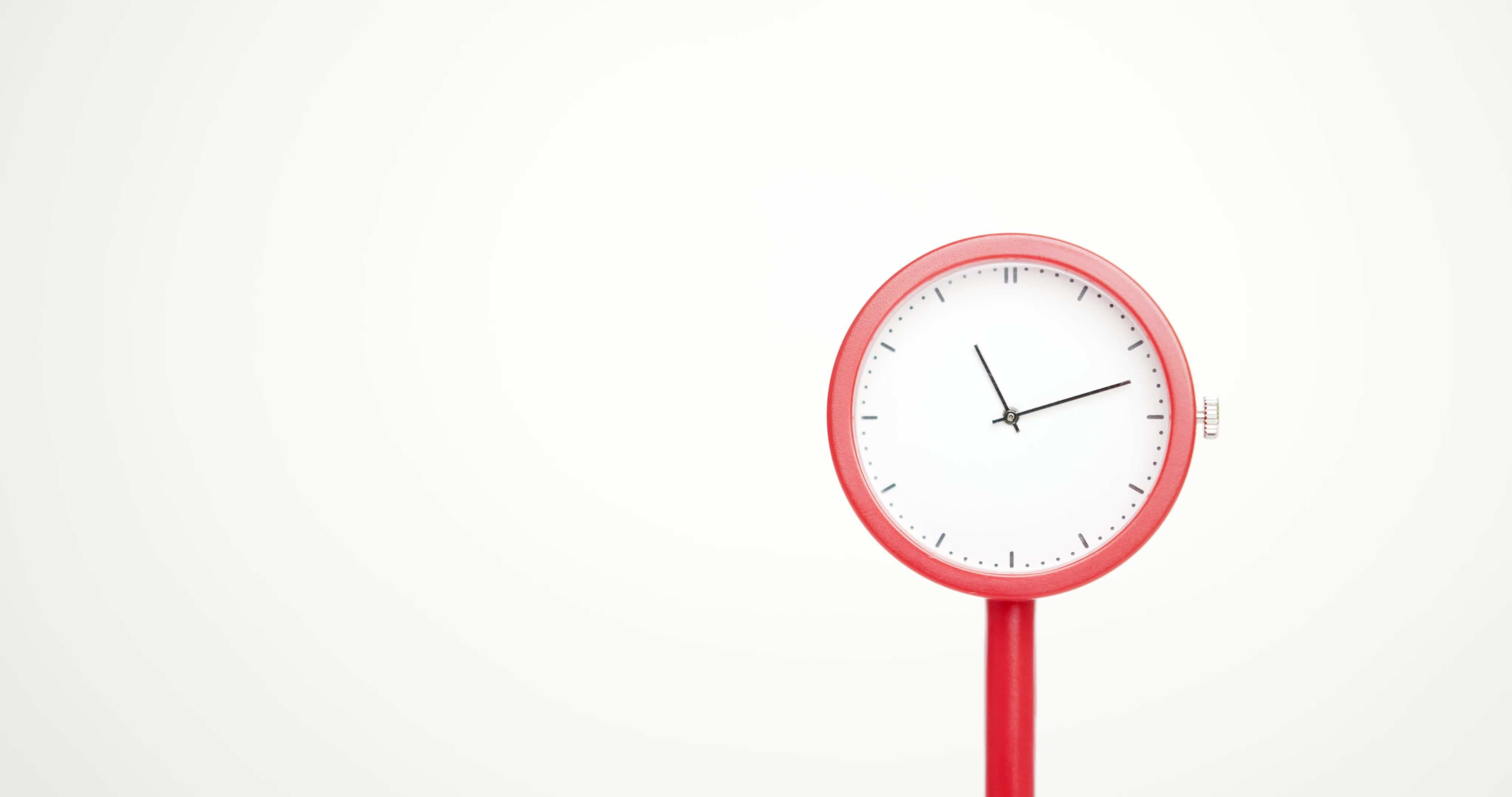 Simple red clock, the dial does not show numbers. Time starts walking