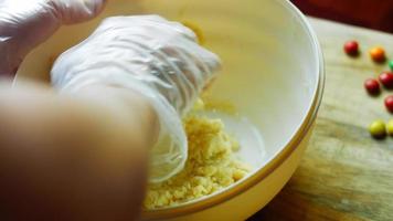 Mix the cake ingredients with the mixer. The baby is sitting in a chair and enjoying himself video