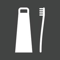 Toothbrush and Toothpaste Glyph Inverted Icon vector