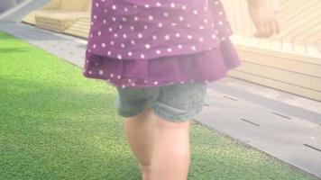 close up video little girl Smile on the grass in playground in the evening before sunset. vintage old film look