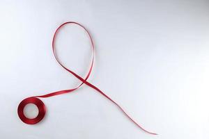 Red Support Ribbon isolated on white background. World aids day and national HIV AIDS and aging awareness month with red ribbon. copyspace area photo