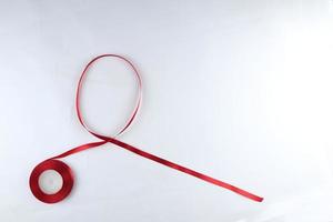 Red Support Ribbon isolated on white background. World aids day and national HIV AIDS and aging awareness month with red ribbon. copyspace area photo