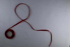 Red Support Ribbon isolated on white background. World aids day and national HIV AIDS and aging awareness month with red ribbon. copyspace area photo