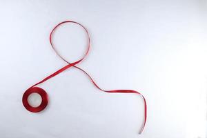 Red Support Ribbon isolated on white background. World aids day and national HIV AIDS and aging awareness month with red ribbon. copyspace area photo