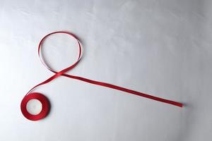 Red Support Ribbon isolated on white background. World aids day and national HIV AIDS and aging awareness month with red ribbon. copyspace area photo