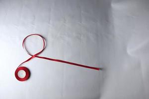 Red Support Ribbon isolated on white background. World aids day and national HIV AIDS and aging awareness month with red ribbon. copyspace area photo