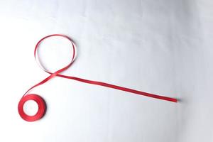 Red Support Ribbon isolated on white background. World aids day and national HIV AIDS and aging awareness month with red ribbon. copyspace area photo