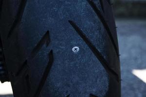 Motorcycle tire leaks due to nail photo