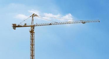 Tower construction cranes with blue sky background photo