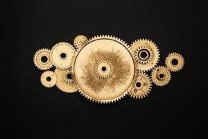 group of golden gears on black background photo