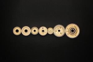 template of seven golden gears on black background photo