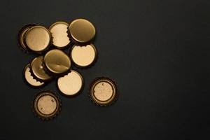 group of bottle caps on black background photo