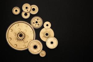 set of golden gears on black background photo