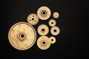 bunch of golden gears on black background photo