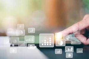 Human hand pointing at tablet, data and document management concept,and audit or performance evaluation, analyzing business financial data, connecting files through cyberspace databases. photo