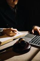 Business and lawyers discussing contract papers with brass scale on desk in office. Law, legal services, advice, justice and law concept photo