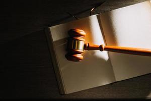 Business and lawyers discussing contract papers with brass scale on desk in office. Law, legal services, advice, justice and law concept photo