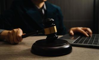 Business and lawyers discussing contract papers with brass scale on desk in office. Law, legal services, advice, justice and law concept photo