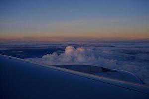 Close up Airplane Wing with Beautiful Skyline Background. photo