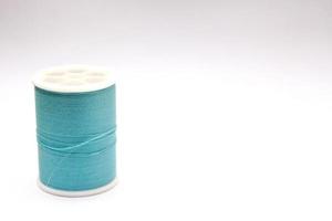 Green thread spools placed on a white background. photo