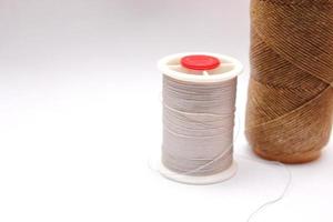 Gray and brown spools are placed on a white background. photo