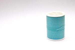 Green thread spools placed on a white background. photo