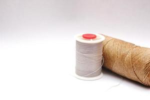 Gray and brown spools are placed on a white background. photo