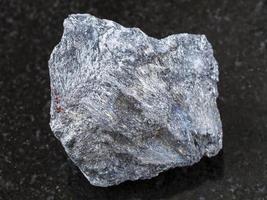 rough antimony ore Stibnite stone on dark photo