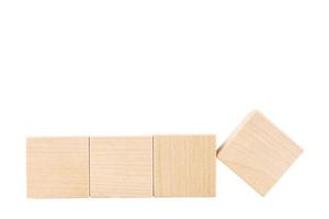 Four wooden cubes, one cube turned over. White isolated background. copy space. photo