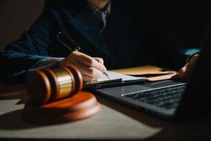 Business and lawyers discussing contract papers with brass scale on desk in office. Law, legal services, advice, justice and law concept picture with film grain effect photo